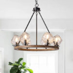 Farmhouse style meets modern minimalist on this Crystal Wood Flyer Chandelier. This vintage-style linear chandelier is compatible with sloped ceilings. 6 irregularly shaped glass lampshade perches on the wooden round base, each designed to house an E12 candelabra base bulb (not included) that adds a candle style to this linear chandelier. Let the warm glow of this embrace you with this farmhouse kitchen island chandelier rustic matte black and wood-like finish.