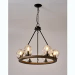 Farmhouse style meets modern minimalist on this Crystal Wood Flyer Chandelier. This vintage-style linear chandelier is compatible with sloped ceilings. 6 irregularly shaped glass lampshade perches on the wooden round base, each designed to house an E12 candelabra base bulb (not included) that adds a candle style to this linear chandelier. Let the warm glow of this embrace you with this farmhouse kitchen island chandelier rustic matte black and wood-like finish.