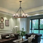 Farmhouse style meets modern minimalist on this Crystal Wood Flyer Chandelier. This vintage-style linear chandelier is compatible with sloped ceilings. 6 irregularly shaped glass lampshade perches on the wooden round base, each designed to house an E12 candelabra base bulb (not included) that adds a candle style to this linear chandelier. Let the warm glow of this embrace you with this farmhouse kitchen island chandelier rustic matte black and wood-like finish.