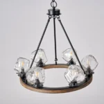 Farmhouse style meets modern minimalist on this Crystal Wood Flyer Chandelier. This vintage-style linear chandelier is compatible with sloped ceilings. 6 irregularly shaped glass lampshade perches on the wooden round base, each designed to house an E12 candelabra base bulb (not included) that adds a candle style to this linear chandelier. Let the warm glow of this embrace you with this farmhouse kitchen island chandelier rustic matte black and wood-like finish.