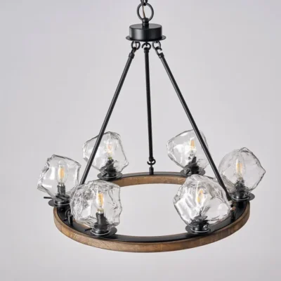 Farmhouse style meets modern minimalist on this Crystal Wood Flyer Chandelier. This vintage-style linear chandelier is compatible with sloped ceilings. 6 irregularly shaped glass lampshade perches on the wooden round base, each designed to house an E12 candelabra base bulb (not included) that adds a candle style to this linear chandelier. Let the warm glow of this embrace you with this farmhouse kitchen island chandelier rustic matte black and wood-like finish.