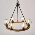 Farmhouse style meets modern minimalist on this Crystal Wood Flyer Chandelier. This vintage-style linear chandelier is compatible with sloped ceilings. 6 irregularly shaped glass lampshade perches on the wooden round base, each designed to house an E12 candelabra base bulb (not included) that adds a candle style to this linear chandelier. Let the warm glow of this embrace you with this farmhouse kitchen island chandelier rustic matte black and wood-like finish.