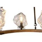 Farmhouse style meets modern minimalist on this Crystal Wood Flyer Chandelier. This vintage-style linear chandelier is compatible with sloped ceilings. 6 irregularly shaped glass lampshade perches on the wooden round base, each designed to house an E12 candelabra base bulb (not included) that adds a candle style to this linear chandelier. Let the warm glow of this embrace you with this farmhouse kitchen island chandelier rustic matte black and wood-like finish.