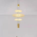 This pendant light has a light source at each end and three frosted glass discs in the center, which allows for better light distribution.
