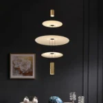 This pendant light has a light source at each end and three frosted glass discs in the center, which allows for better light distribution.