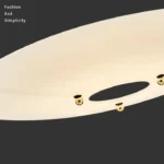 This pendant light has a light source at each end and three frosted glass discs in the center, which allows for better light distribution.