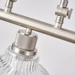 A minimalist masterpiece that seamlessly blends captivating design with functional brilliance, this chandelier transcends the ordinary. Featuring hand-blown glass pendant that commands attention from above, this chandelier will effortlessly accent a space of any size. Suspended elegantly from a sleek metal, the chandelier allows light to playfully dance within its clear glass confines, creating a mesmerizing interplay of shadows and illumination. Combining high-quality metal construction and adjustable height functionality, this pendant light fixture offers a unique lighting experience.