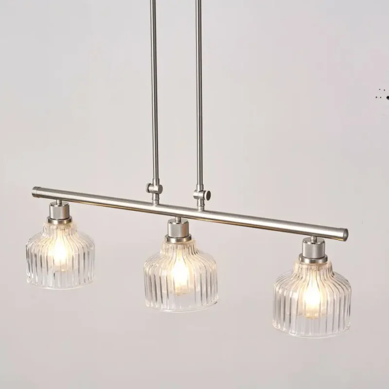 A minimalist masterpiece that seamlessly blends captivating design with functional brilliance, this chandelier transcends the ordinary. Featuring hand-blown glass pendant that commands attention from above, this chandelier will effortlessly accent a space of any size. Suspended elegantly from a sleek metal, the chandelier allows light to playfully dance within its clear glass confines, creating a mesmerizing interplay of shadows and illumination. Combining high-quality metal construction and adjustable height functionality, this pendant light fixture offers a unique lighting experience.