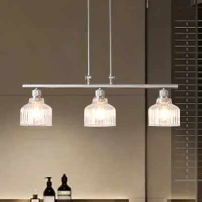 A minimalist masterpiece that seamlessly blends captivating design with functional brilliance, this chandelier transcends the ordinary. Featuring hand-blown glass pendant that commands attention from above, this chandelier will effortlessly accent a space of any size. Suspended elegantly from a sleek metal, the chandelier allows light to playfully dance within its clear glass confines, creating a mesmerizing interplay of shadows and illumination. Combining high-quality metal construction and adjustable height functionality, this pendant light fixture offers a unique lighting experience.