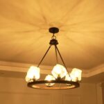 Farmhouse style meets modern minimalist on this Crystal Wood Flyer Chandelier. This vintage-style linear chandelier is compatible with sloped ceilings. 6 irregularly shaped glass lampshade perches on the wooden round base, each designed to house an E12 candelabra base bulb (not included) that adds a candle style to this linear chandelier. Let the warm glow of this embrace you with this farmhouse kitchen island chandelier rustic matte black and wood-like finish.