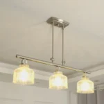 A minimalist masterpiece that seamlessly blends captivating design with functional brilliance, this chandelier transcends the ordinary. Featuring hand-blown glass pendant that commands attention from above, this chandelier will effortlessly accent a space of any size. Suspended elegantly from a sleek metal, the chandelier allows light to playfully dance within its clear glass confines, creating a mesmerizing interplay of shadows and illumination. Combining high-quality metal construction and adjustable height functionality, this pendant light fixture offers a unique lighting experience.